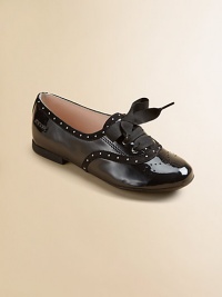 This lustrous patent leather style combines elegance and fun, with dotted trim, wingtip-look perforations and wide grosgrain ribbon laces that tie in pretty bows.Lace-up frontLeather upperLeather solePadded insoleImported