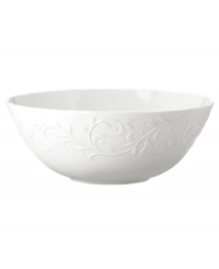 An elegant white-on-white pattern featuring an embossed vine motif and interior glaze lends the Opal Innocence Carved serving bowl to refined dining every day.