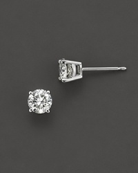 Classic diamond stud earrings sparkle, elegantly set in 14K white gold.