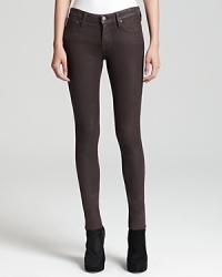 Glossy HELMUT skinny jeans shine the spotlight on your directional style sense for a dose of downtown attitude.