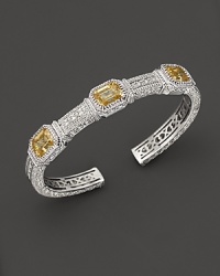 Sterling silver cuff set with emerald cut canary crystals. By Judith Ripka.