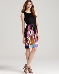 Crisp florals look three dimensional against against a black Elie Tahari dress. A ribbon belt cinches the classic silhouette for a 9-to-5 style blooming with feminine sophistication.