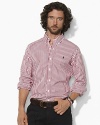 A polished stripe motif adds timeless style to a trim-fitting sport shirt in crisp cotton poplin.