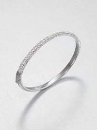 From the Brilliance Collection. Half of this graceful bangle is paved with sparkling rhinestones, the other half has a smooth, polished finish, with a handy hinge in between.GlassSilvertoneDiameter, about 2.5Hinged with push-lock claspImported