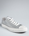 Add these Converse Chuck Taylor sneakers to your collection; in statement-making herringbone glitter they will shine with both casual basics and dressed-up styles.