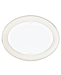 Refine your formal table with classic cream and white Lenox dinnerware. Dishes, including this Opal Innocence Scroll bone china oval platter, are trimmed in platinum and accented with a raised dot and scroll pattern, bringing contemporary grace to special occasions. A pearlized finish adds subtle shimmer.