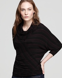 Bold stripes and stylish Dolman sleeves enrich this knit turtleneck as the layering season approaches.