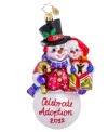 Cheer for a worthy cause. Handcrafted by Christopher Radko, the Celebrate Adoption 2012 ornament benefits the Dave Thomas Foundation, an organization that finds families for waiting children and raises awareness about adoption.