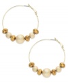 Clusters of gold tone diamond-blasted and faceted beads shine on these Alfani hoop earrings. Crafted in 12k gold-plated mixed metal. Approximate drop: 1-7/8 inches.