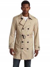 Lightweight and packable, this double breasted trench classic folds into itself and features water resistant fabric construction so you can brave the elements in style.Point collar with hook-and-eye Epaulettes Double breasted button front Single gun flap Long sleeves with belted cuffs Dual side pocketsBuckled belt Storm flap One inside zip pocket Fully lined About 35½ from shoulder to hem Polyester; hand wash Imported