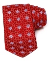 A subtle floral print takes form on luxe silk with this classic tie from Ike Behar.