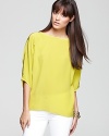 Look smart and chic in a Vince silk top, popping up in a sprightly neon hue.