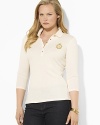 Sleek gold-toned buttons and a metallic embroidered crest lend regal elegance to a soft cotton polo shirt.