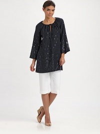 An enticing tunic with spectacular beading, a flattering fit and convenient slash pockets. Round neckSelf-tieThree-quarter sleevesSlash pocketsPull-on styleAbout 32 from shoulder to hemLinenDry cleanImported