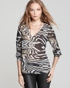 Tap into your animal instincts and one of the top trends of the season with this sheer and silky soft PJK Patterson J. Kincaid top that features a bold zebra print.