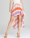 Enlivened by a colorful print, this GUESS skirt flaunts an elongated back hem for head-turning drama.