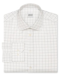 A measured tattersall design composed of thin, subtle lines highlights this refined cotton dress shirt, tailored for a contemporary fit to mesh seamlessly with your modern wardrobe.