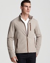 Leather accents trim zippered details on Michael Kors' racer jacket, a lightweight layer with a modern, masculine look.