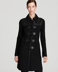 Cut a sharp silhouette in this DKNY coat, flaunting sleek tailoring and clean lines for modern sophistication. Leather insets finish the style with downtown edge.