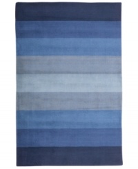 Hand-tufted, blended wool gives an exceptionally soft feel to this rug from the Coastal Treasures collection. In a shimmering, striped design of ocean-blue colorways, this sophisticated piece adds serene character to every decor.