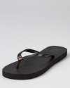 A petite logo gleams at the front of these versatile flip flops, the perfect tool for chic summer style. From Tory Burch.