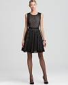 Playful polka dots take on a timeless black & nude color palette, trimmed in grosgrain accents. From DKNY.