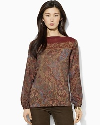 A slightly sheer georgette blouse is rendered with an allover floral pattern, adding feminine allure to any wardrobe.