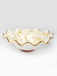 This remarkably unique bowl, in hand-painted terra cotta with color-dragged checks and golden trim, creates an ultra-glamorous presentation piece for you and your guests.Ceramic with golden lustre14.5 diam.Hand washMade in the USA