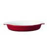 The Emile Henry classic oval gratin dish is shallow enough to spread a thin layer of food with a perfectly browned crust or topping. The handles make it easy to remove the dish from the oven with pot holders or oven gloves and is designed with shallow sloping sides, to ease out the cooked food. Shown in red.