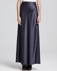 A flowing Vince maxi skirt flaunts a luxe metallic shine, creating an elegant evening look perfect for cocktails or a chic al fresco engagement.