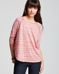 Paired with signature denim, this soft knit ALTERNATIVE tee with tonal stripes creates a colorful, casual ensemble.