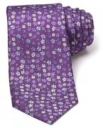 Adorned with a pattern of tonal flowers on a slightly textured background, this luxuriously soft tie freshens up your professional wardrobe with a dash of rich color.