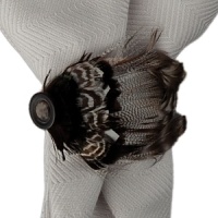 Natural feathers add a touch of organic elegance to this napkin ring from Juliska.