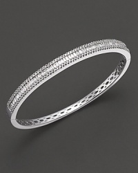 Round and baguette, white gold diamond bangle in 14 kt. white gold.