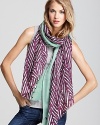 Cozy cashmere takes an unexpected turn with DIANE von FURSTENBERG's purple zebra-print scarf.