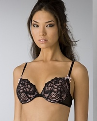 A padded bra with rose lace detail and bow detail at adjustable straps. Hook and eye closure. Style #723607