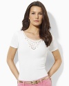 Delicate Battenburg lace gracefully accents a soft cotton tee for modern, feminine appeal.