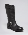 GUESS reinvents the classic moto boot in luxe leather, with bold buckled details.