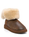 UGG® Australia distressed leather ankle boots with genuine shearling lining will keep your feet in ultimate comfort. Shearling cuff can be worn up or down for a more versatile look. Functional elastic loop and button at side and rubber wafer sole.