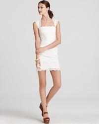 At once daring and demure, this curve-defining Nicole Miller dress is fashioned in delicate lace.