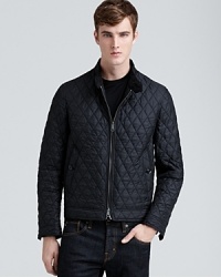 The allover diamond quilting of this classic nylon bomber jacket reveals military inspiration and cunning craftsmanship from Burberry Brit, a thoroughly masculine design that has wear-anywhere versatility.