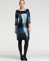 A cascade of ombre sequins lends fluid dimension to a standout Karen Kane Plus dress. Accentuate the shimmery silhouette with sleek silver accents and ignite the night.