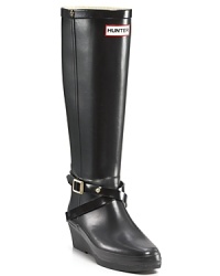 A new boot from Hunter! Tall wedge rain boots with criss-cross buckle straps at ankle.