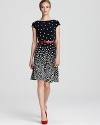 A swing skirt lends a ladylike look to this belted Anne Klein dress, printed with piling-up polka dots.