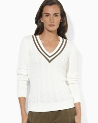 Sporty stripes at the neckline give this sleek cotton knit sweater a hint of athletic edge for a woman on the go.