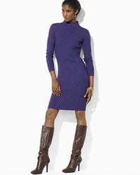 Rendered in luxurious merino wool, a ribbed, form-fitting mockneck dress exudes timeless sophistication.