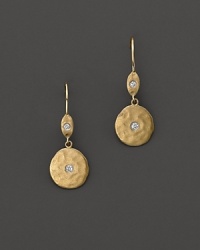 Hammered gold disc earrings are accented with diamond centers, for pierced ears. Designed by Meira T.