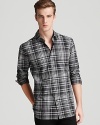 A check-printed cotton sport shirt boasts a classic color palette and a slim fit.