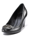 Classic Tory Burch leather wedge pumps with leather logo ornamentation at toe.