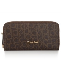 Organization with elegance. This luxe lovely from Calvin Klein will keep your credentials in signature style. Outfitted with the iconic CK monogram, it flaunts multiple pockets and compartments for effortless go-everywhere accessorizing.